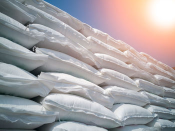 Low angle view of sacks against sky during sunset