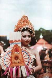 Portrait of young woman holding umbrella