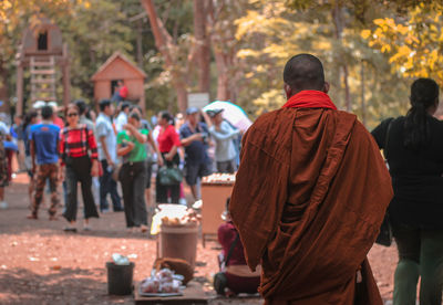 Rear view of monk walking at religious place