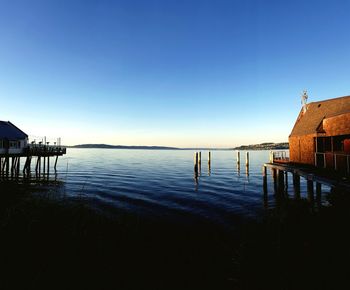 Calm blue sea against clear sky