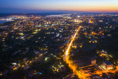 High angle view of city lit up at night