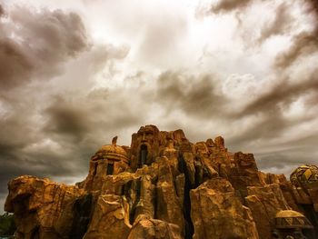 Low angle view of rock formation against sky