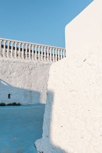 Bridge over sea against clear blue sky