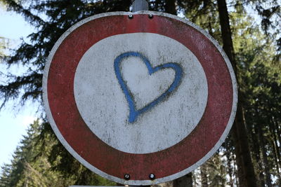 Close-up of heart shape sign on tree