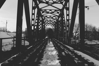 Rear view of man on bridge in winter