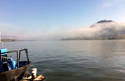 Boat sailing in lake against sky