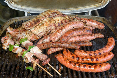 High angle view of meat on barbecue grill