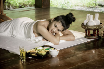 Young woman lying on table