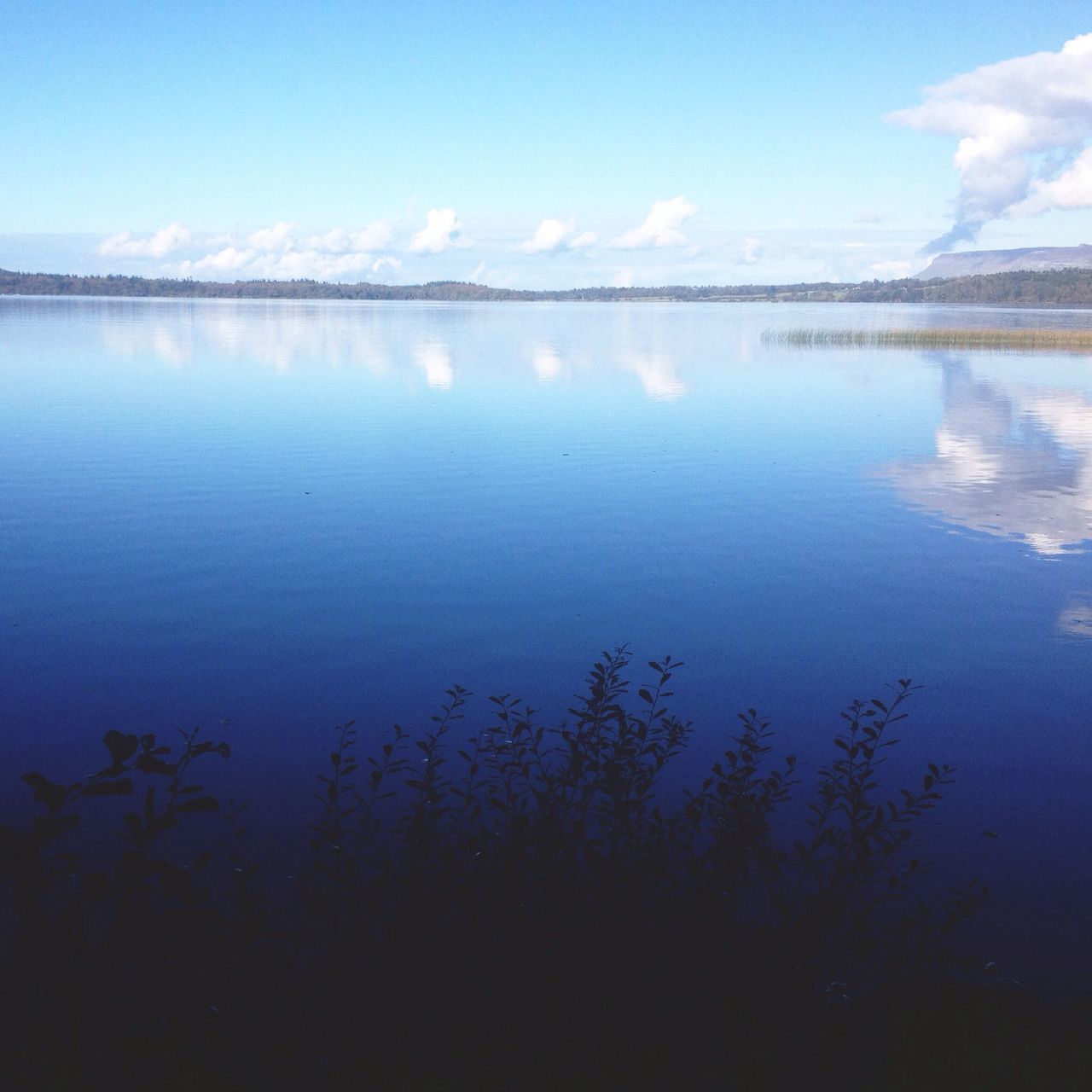 water, tranquil scene, tranquility, lake, scenics, reflection, beauty in nature, sky, nature, tree, blue, idyllic, calm, standing water, lakeshore, cloud - sky, outdoors, non-urban scene, cloud, no people