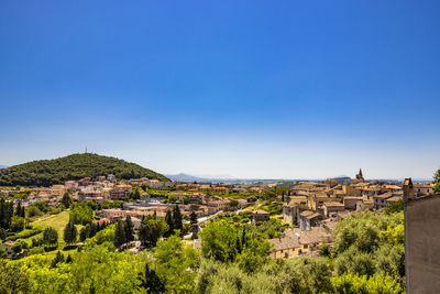 Panoramic view of townscape against clear blue sky
