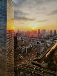 Aerial view of cityscape against sky during sunset