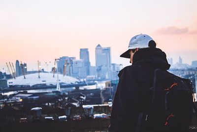 Rear view of man looking at cityscape