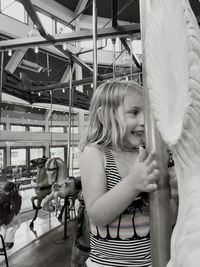 Little girl enjoying on carousel at amusement park