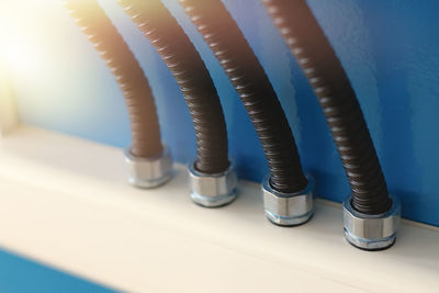 Close-up of pipe on table against wall