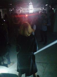 Rear view of women standing at music concert