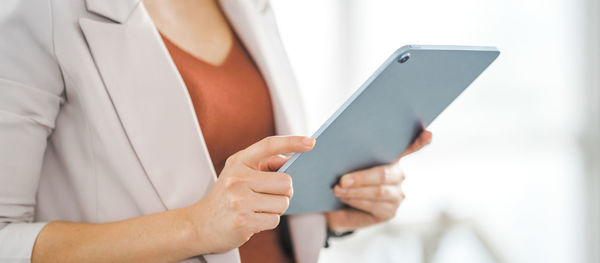 Midsection of woman using mobile phone