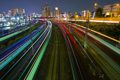 High angle view of light trails on street amidst buildings