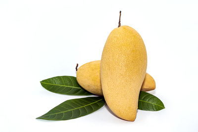 Close-up of fresh yellow fruits against white background