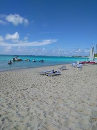 Scenic view of beach against blue sky