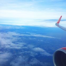 Aerial view of aircraft wing against sky