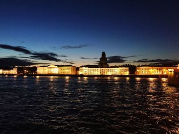 Illuminated buildings with waterfront at night