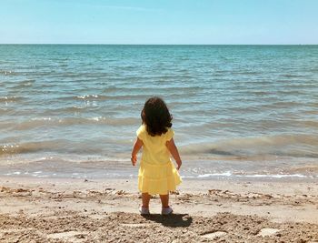 Rear view of children on beach