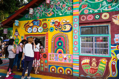 People walking on multi colored building