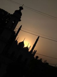 Low angle view of silhouette buildings against sky during sunset