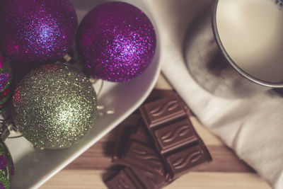 Close-up of chocolate with baubles on table