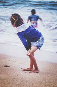 Side view of girl standing at beach