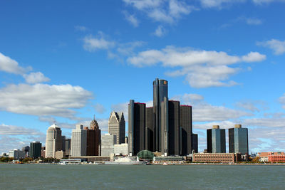 Skyscrapers in city against cloudy sky