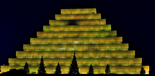 Low angle view of modern building against sky at night