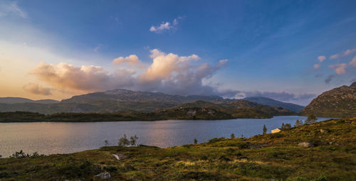 Scenic view of lake and mountains against sky