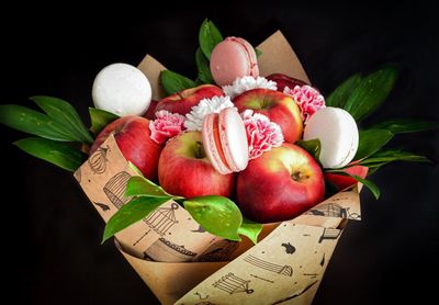 Close-up of fresh fruits and vegetables on table against black background