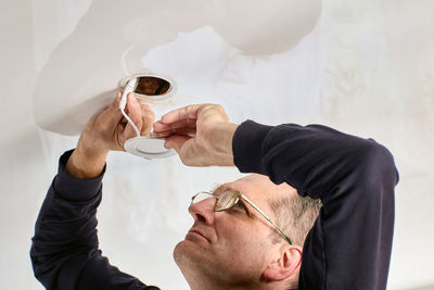 Side view of woman holding hands