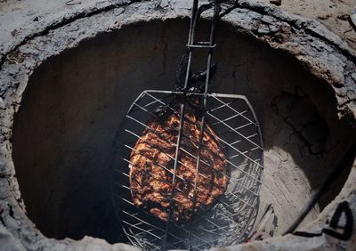 Low angle view of barbecue grill against wall