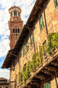 Low angle view of clock tower against cloudy sky