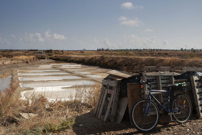 Bicycle on field against sky