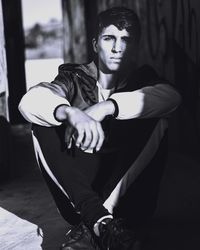 Portrait of young man sitting outdoors