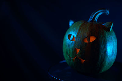 Close-up of jack o lantern against blue background