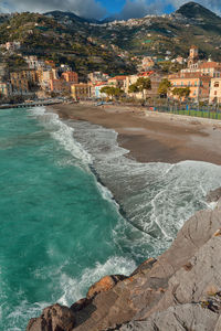 Scenic view of beach by buildings in city