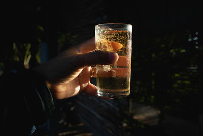 Close-up of hand holding beer glass