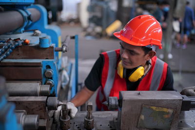 Portrait of male worker standing in the heavy industry manufacturing factory.