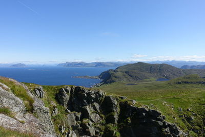 Scenic view of landscape and mountains against clear blue sky