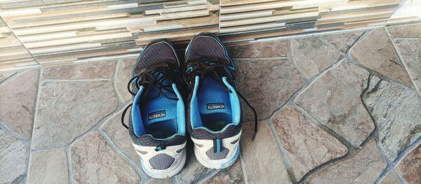 High angle view of shoes on tiled floor