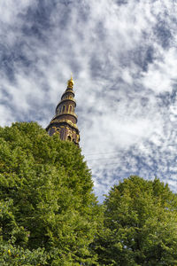 Low angle view of temple building against cloudy sky