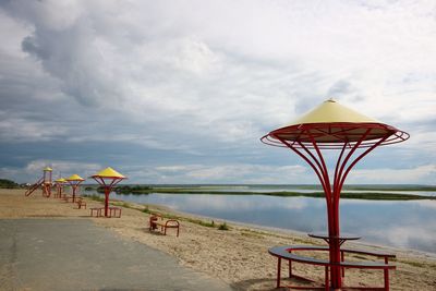 Lifeguard hut on beach against sky