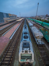 High angle view of train at railroad station against sky