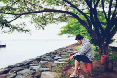 Full length rear view of man looking at sea