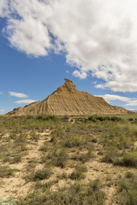 Scenic view of field and mountain against sky